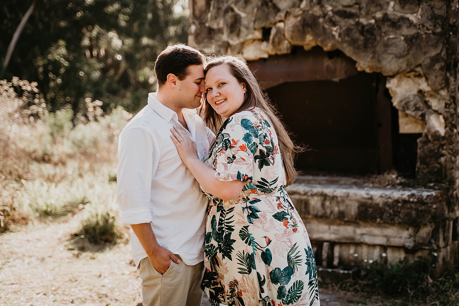 Man nuzzling his head against woman's in front of ruined chimney Riverbend Park Engagement Photography captured by South Florida Engagement Photographer Krystal Capone Photography 