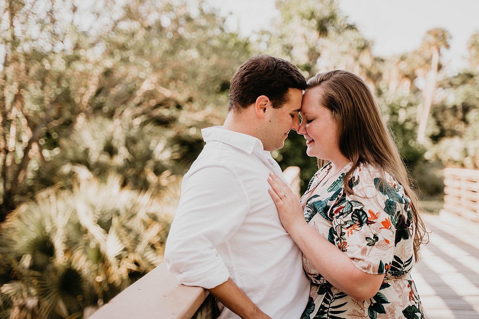 Couple touching their noses on wooden bridge Riverbend Park Engagement Photography captured by South Florida Engagement Photographer Krystal Capone Photography 