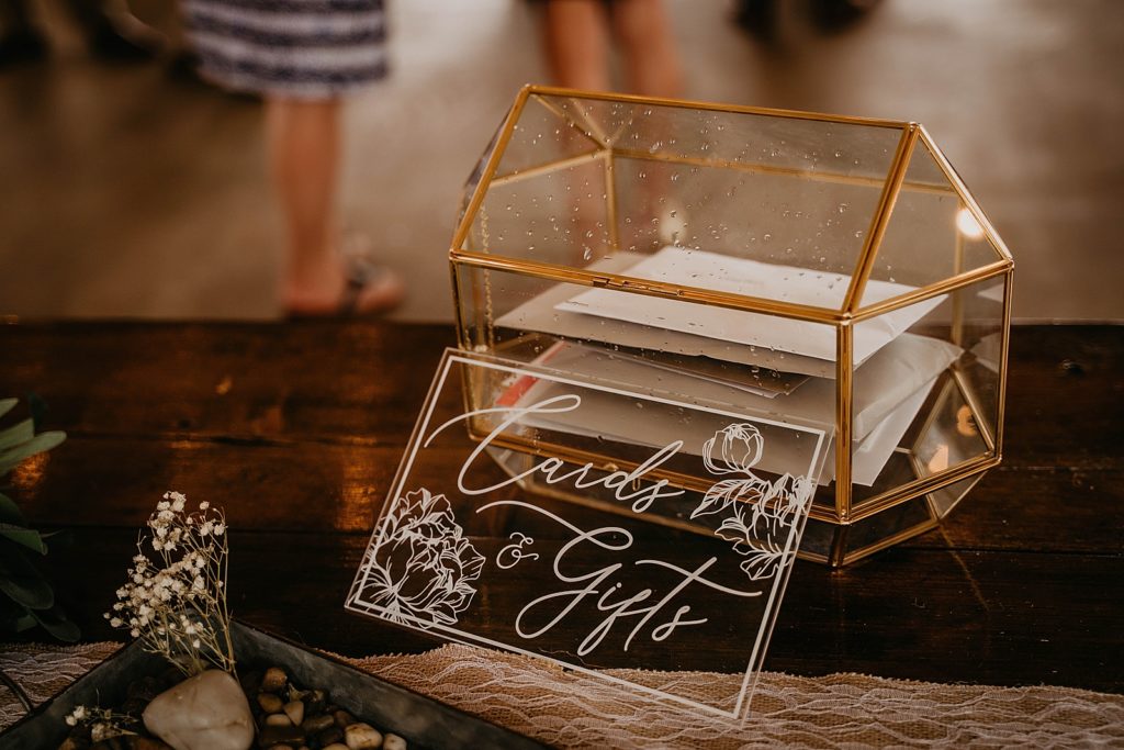 Detail shot of clear gold rimmed card and gift box The Lake House Fort Pierce Wedding Photography captured by South Florida Wedding Photographer Krystal Capone Photography 