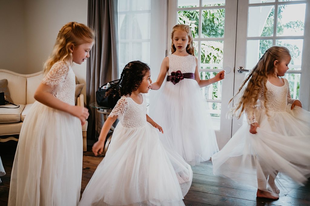 Getting ready shot of little girls in their white dresses The Lake House Fort Pierce Wedding Photography captured by South Florida Wedding Photographer Krystal Capone Photography 