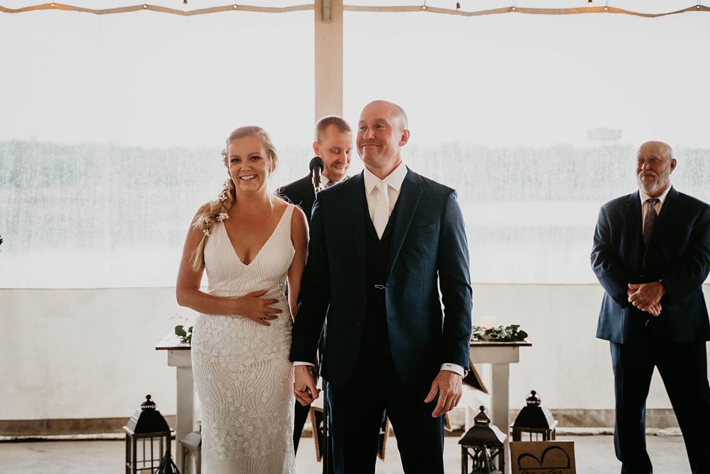 Bride and Groom just married beginning exit The Lake House Fort Pierce Wedding Photography captured by South Florida Wedding Photographer Krystal Capone Photography 