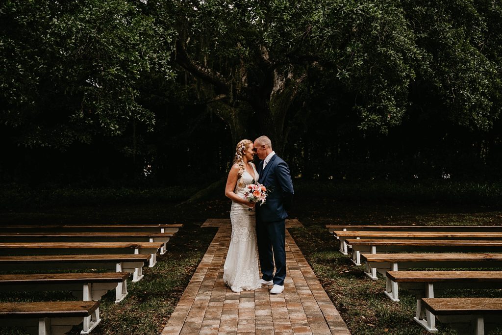 Bride and Groom resting their heads against each other The Lake House Fort Pierce Wedding Photography captured by South Florida Wedding Photographer Krystal Capone Photography 