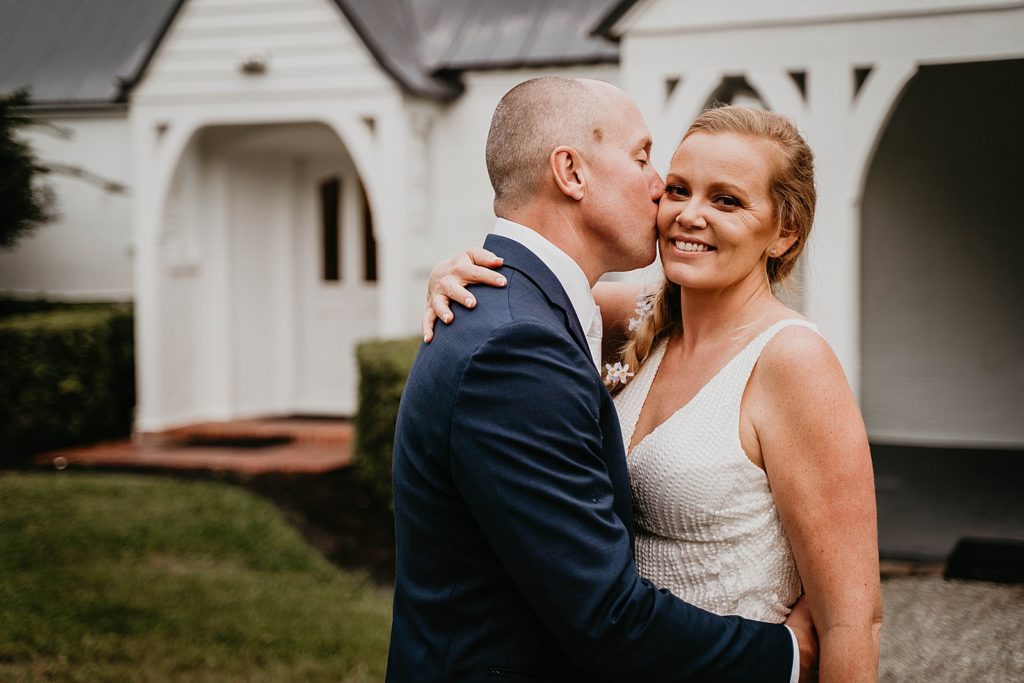 Groom kissing Bride on the cheek The Lake House Fort Pierce Wedding Photography captured by South Florida Wedding Photographer Krystal Capone Photography 