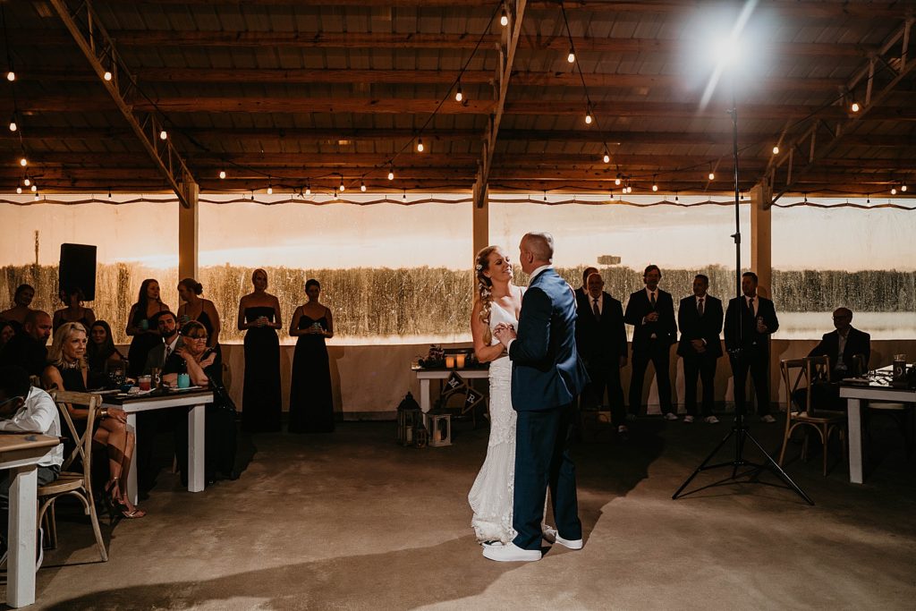 Bride and Groom first dance everyone watching The Lake House Fort Pierce Wedding Photography captured by South Florida Wedding Photographer Krystal Capone Photography 