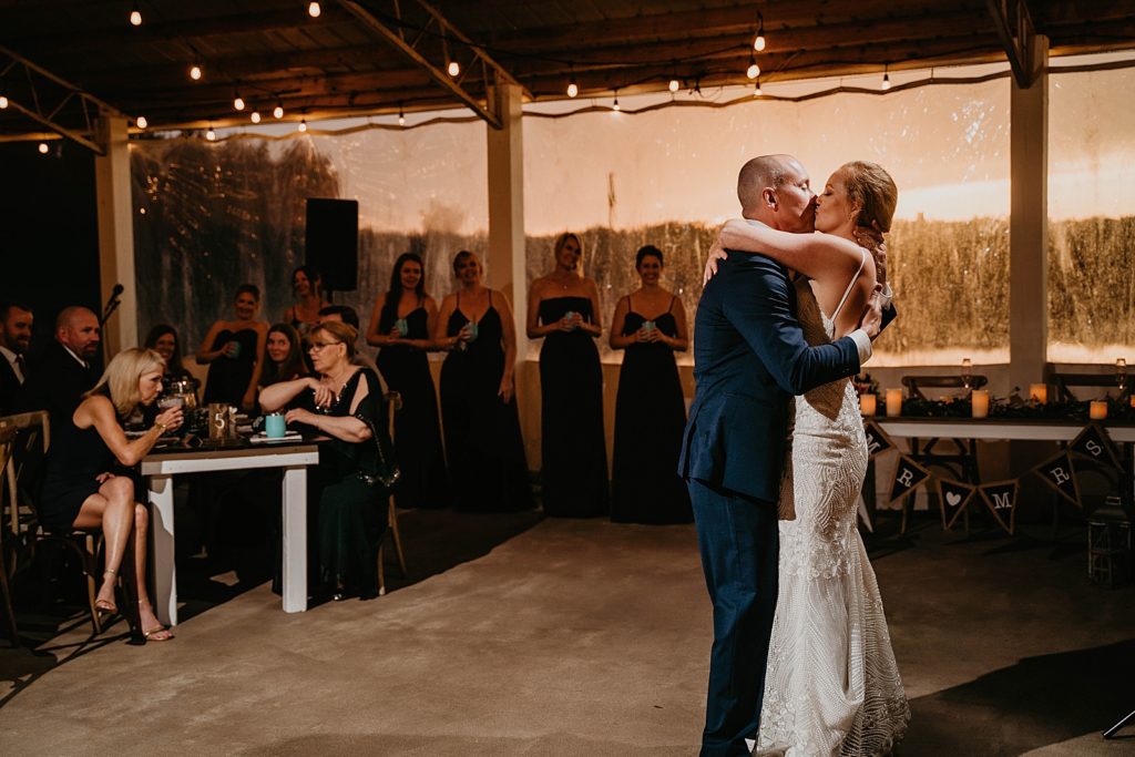 Bride and Groom kissing after first dance The Lake House Fort Pierce Wedding Photography captured by South Florida Wedding Photographer Krystal Capone Photography 