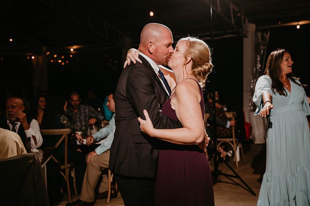 Bride and Groom dancing and kissing during first dance The Lake House Fort Pierce Wedding Photography captured by South Florida Wedding Photographer Krystal Capone Photography 