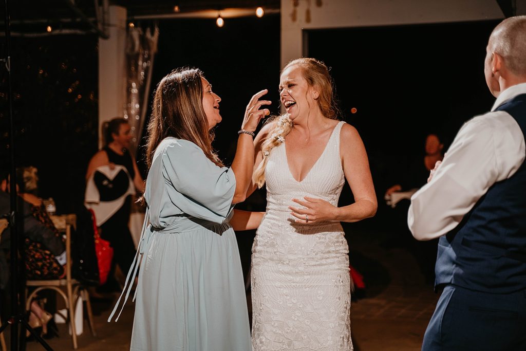 Bride laughing on Reception dance floor The Lake House Fort Pierce Wedding Photography captured by South Florida Wedding Photographer Krystal Capone Photography 