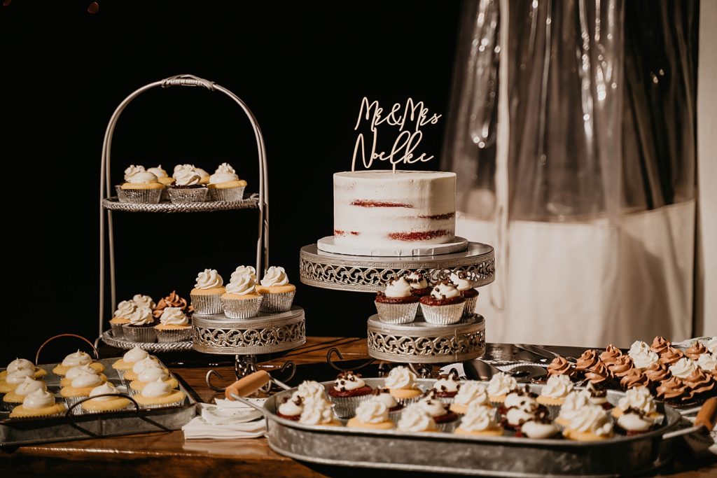 Reception detail shot of single tier wedding cake with vanilla ad chocolate cupcakes The Lake House Fort Pierce Wedding Photography captured by South Florida Wedding Photographer Krystal Capone Photography 