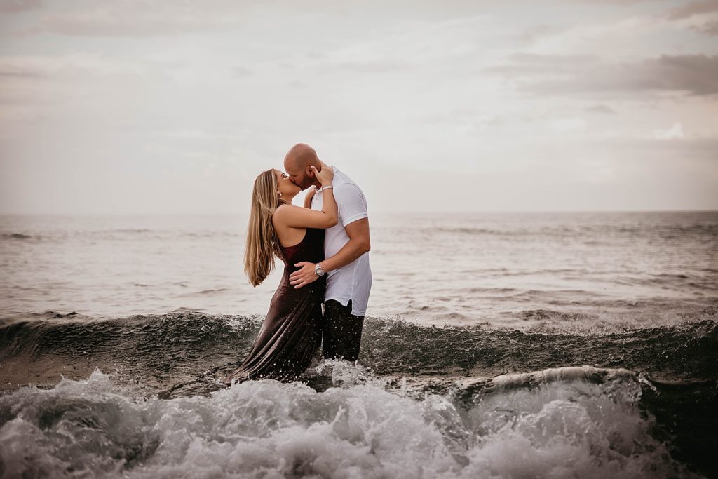 Couple kissing knee deep in the ocean