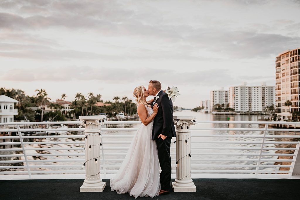 Bride and Groom kissing on the water