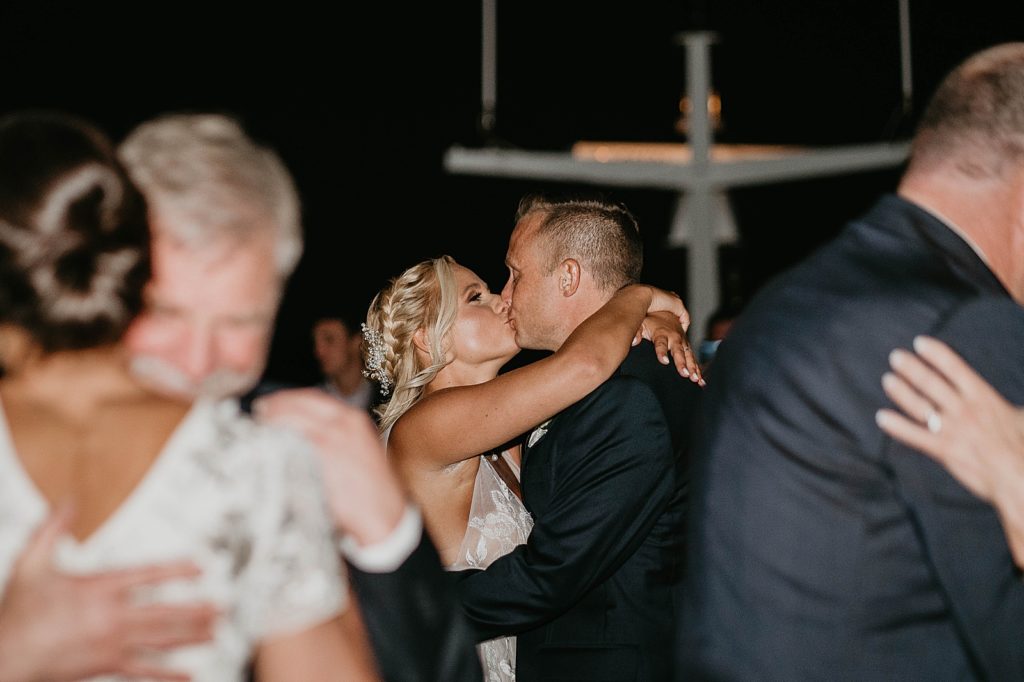 Bride and Groom kissing during slow dance at night