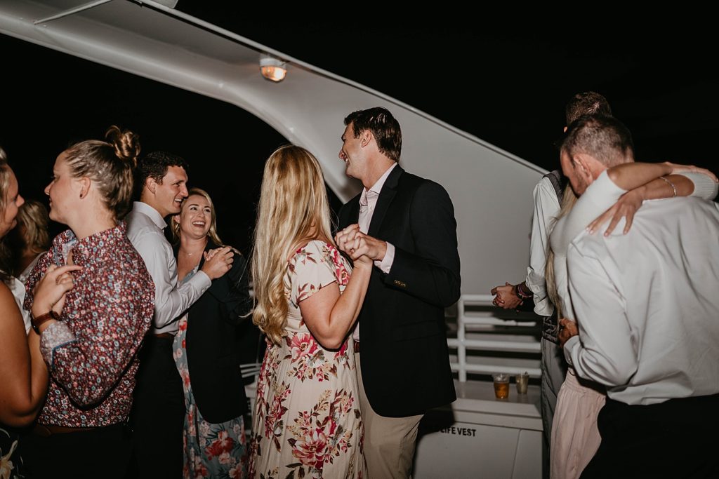 Guests slow dancing on yacht at night