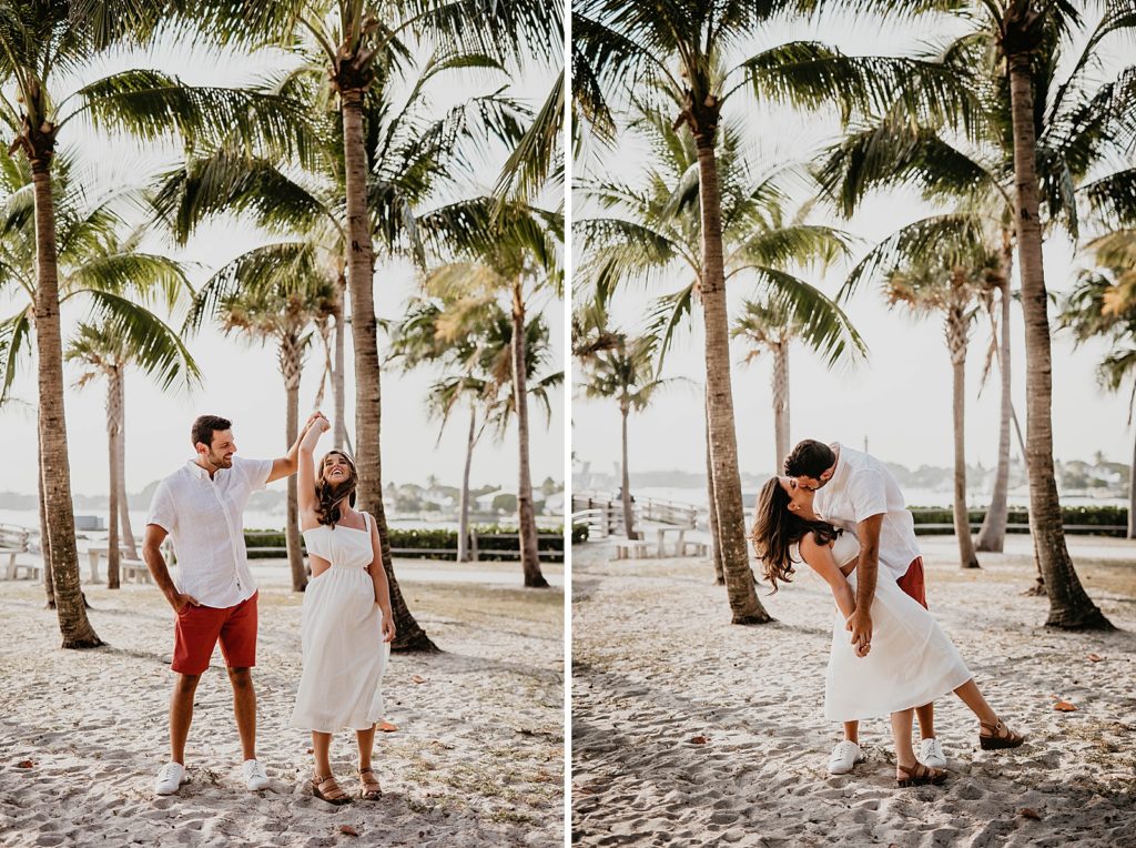 Couple twirling and dipping on the sand by the palm trees