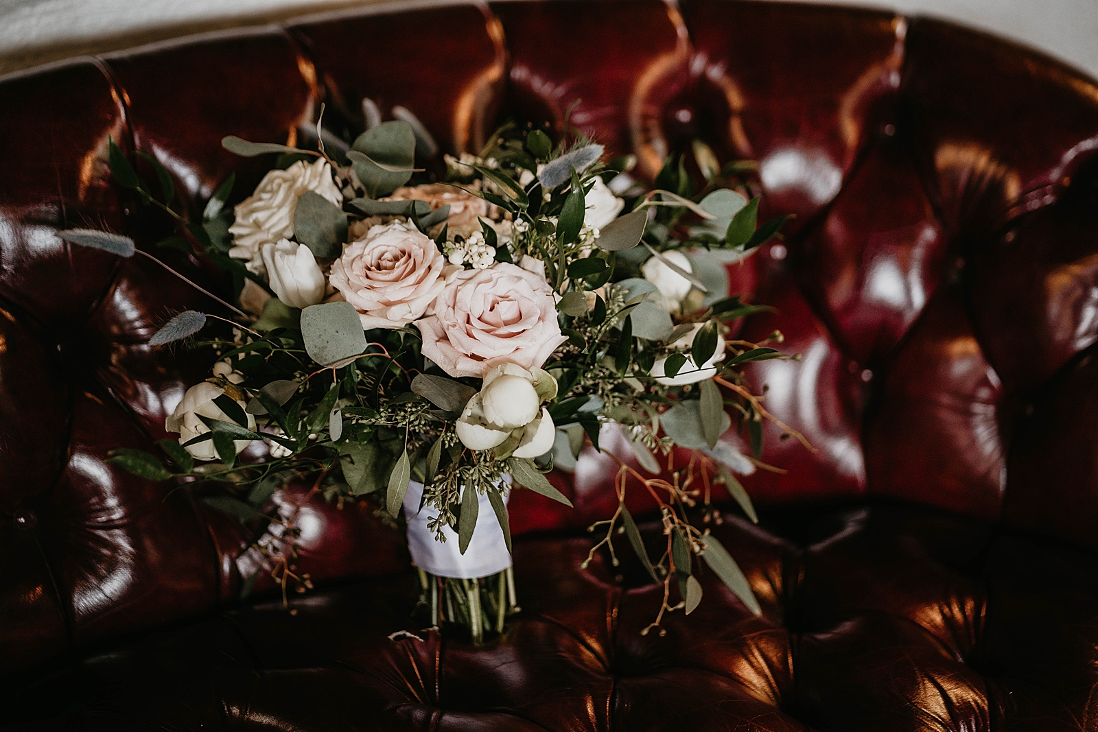 Detail shot of bouquet on leather chair