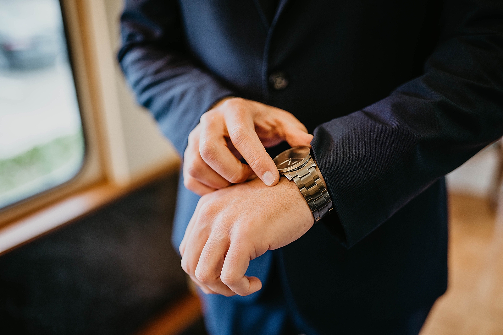 Detail shot of Groom putting on his watch