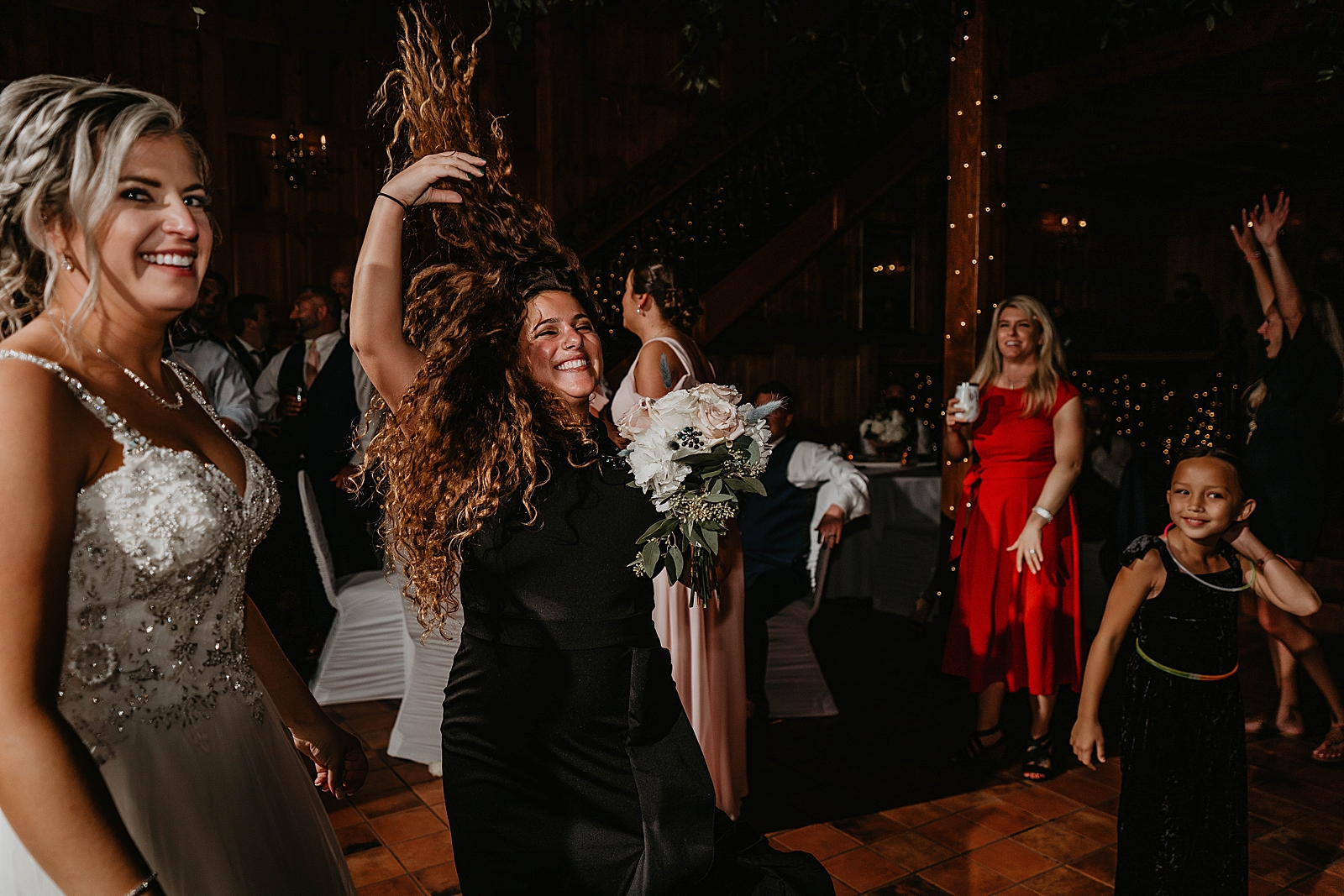Woman celebrating she caught the bouquet at Reception