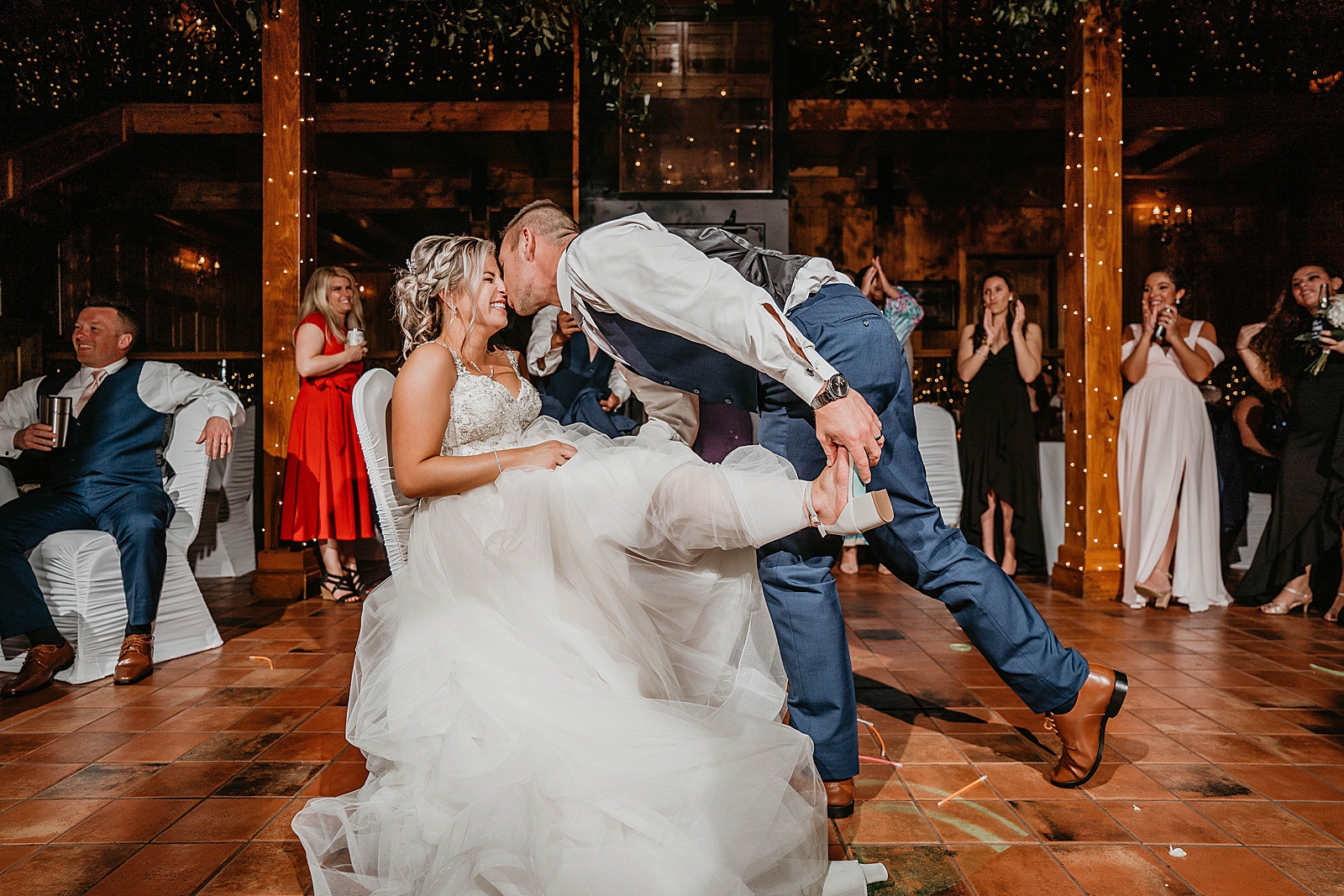 Groom kissing Bride for garter toss