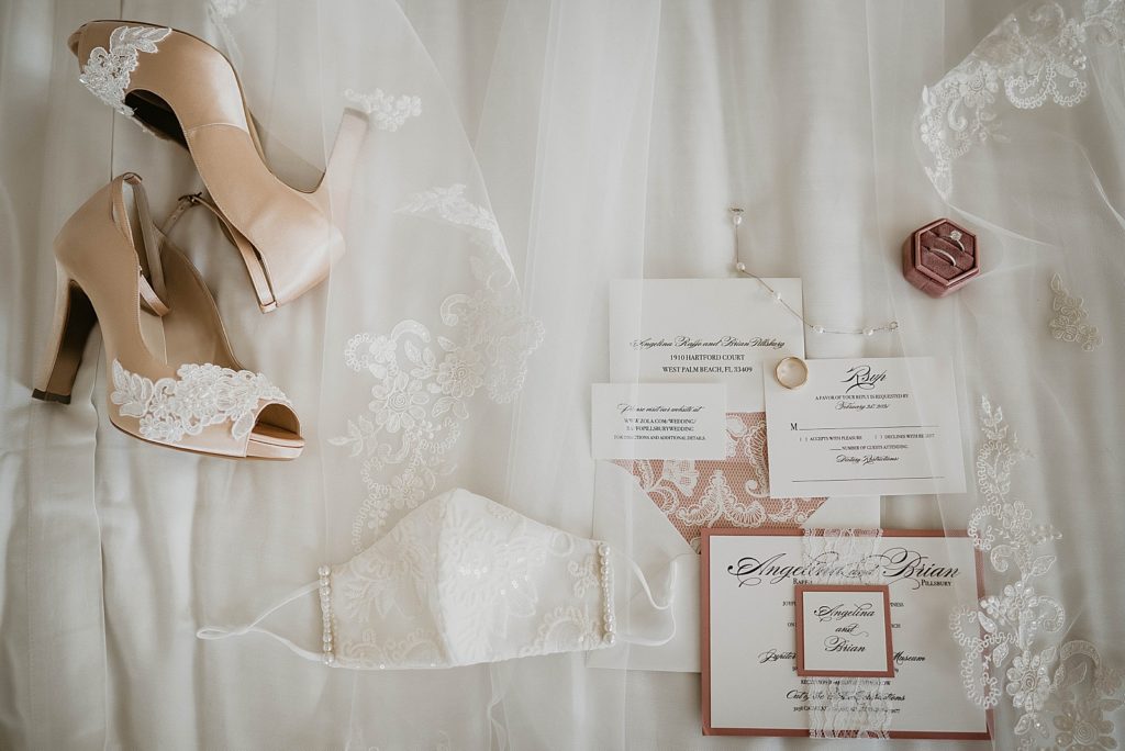 Detail shot of Bride's mask shoes and invitations