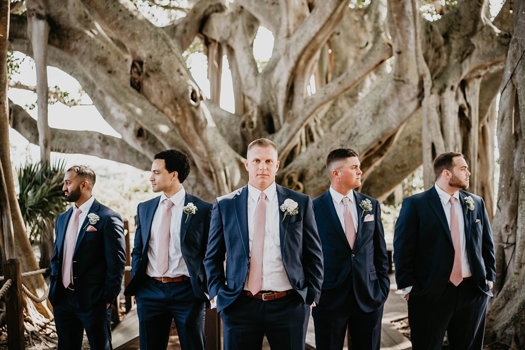 Groom and Groomsmen in formal pose in front of Banyan tree