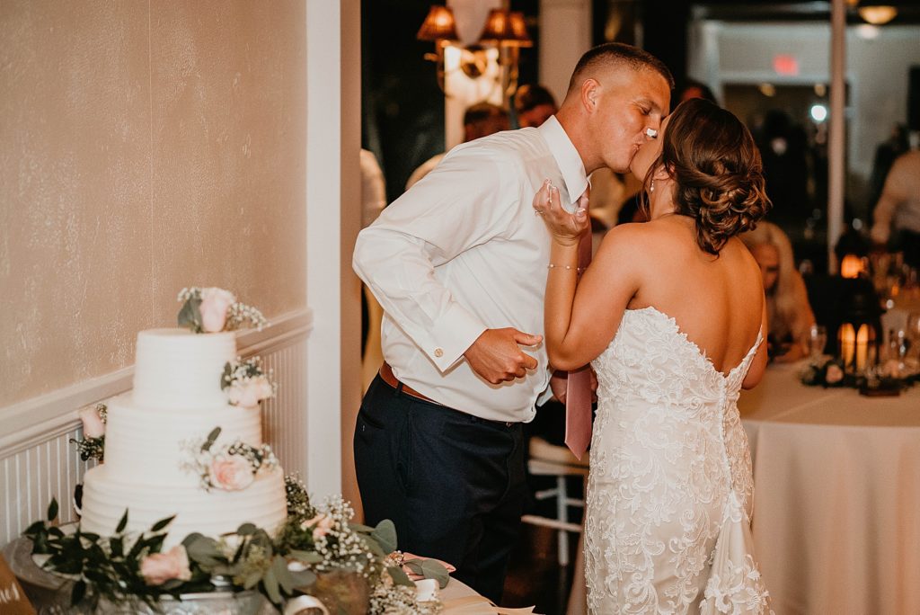 Bride and Groom kissing after cake cutting