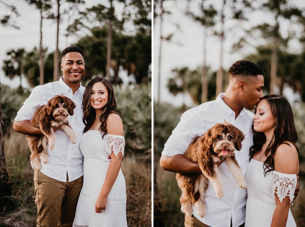 Couple holding each other with man holding dog