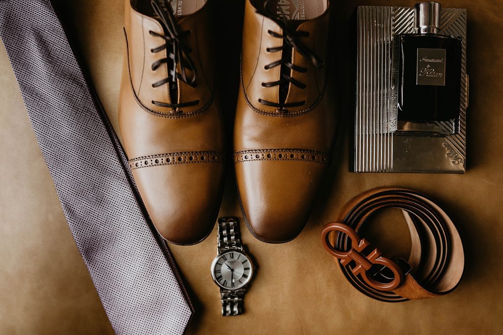 Detail shot of Groom's shoes watch tie and belt