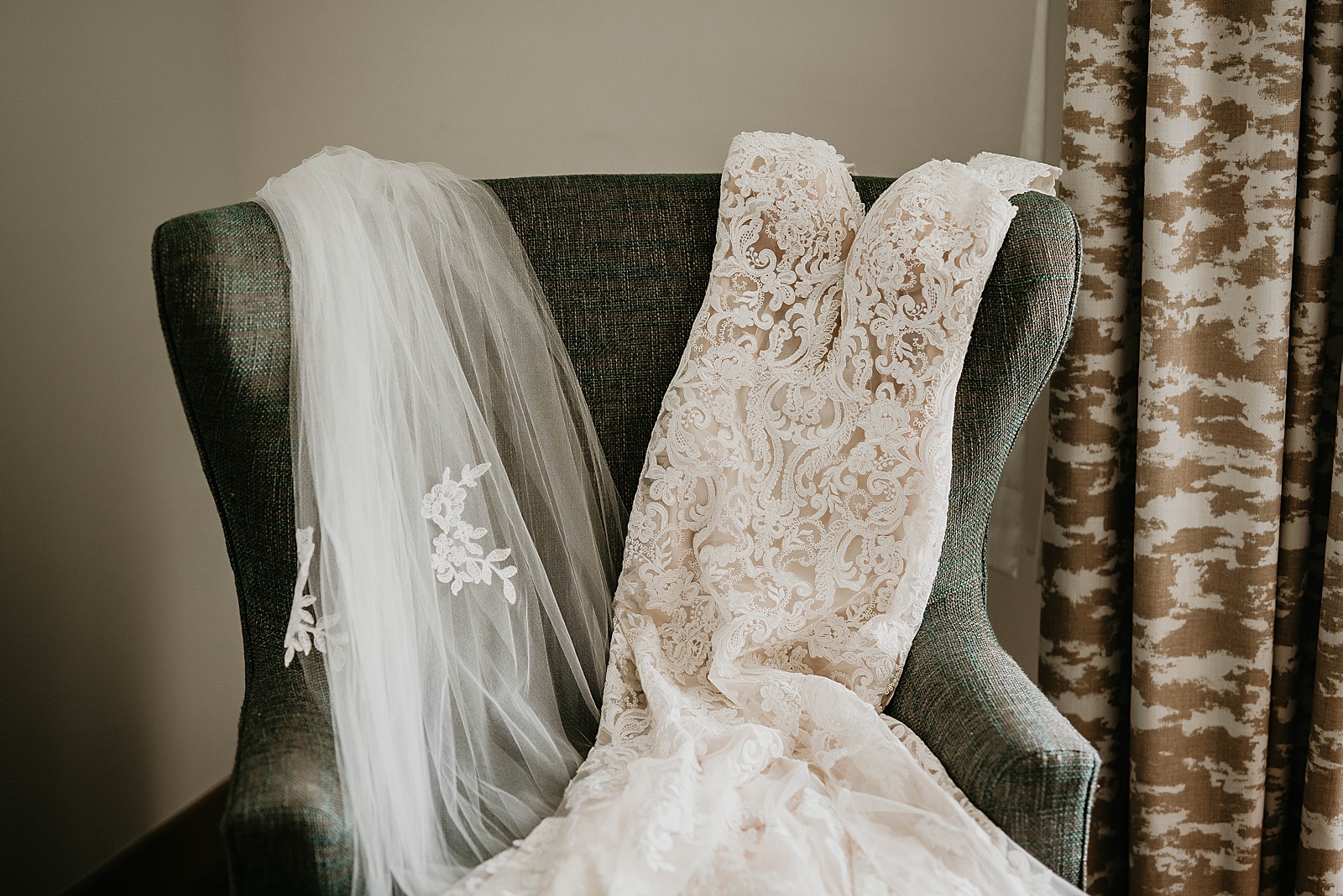 Wedding dress and veil draping on fabric chair