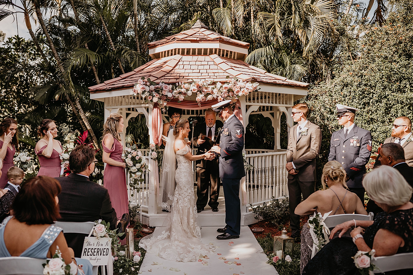 Bride and Groom holding hands during Homily Ceremony under Gazebo
