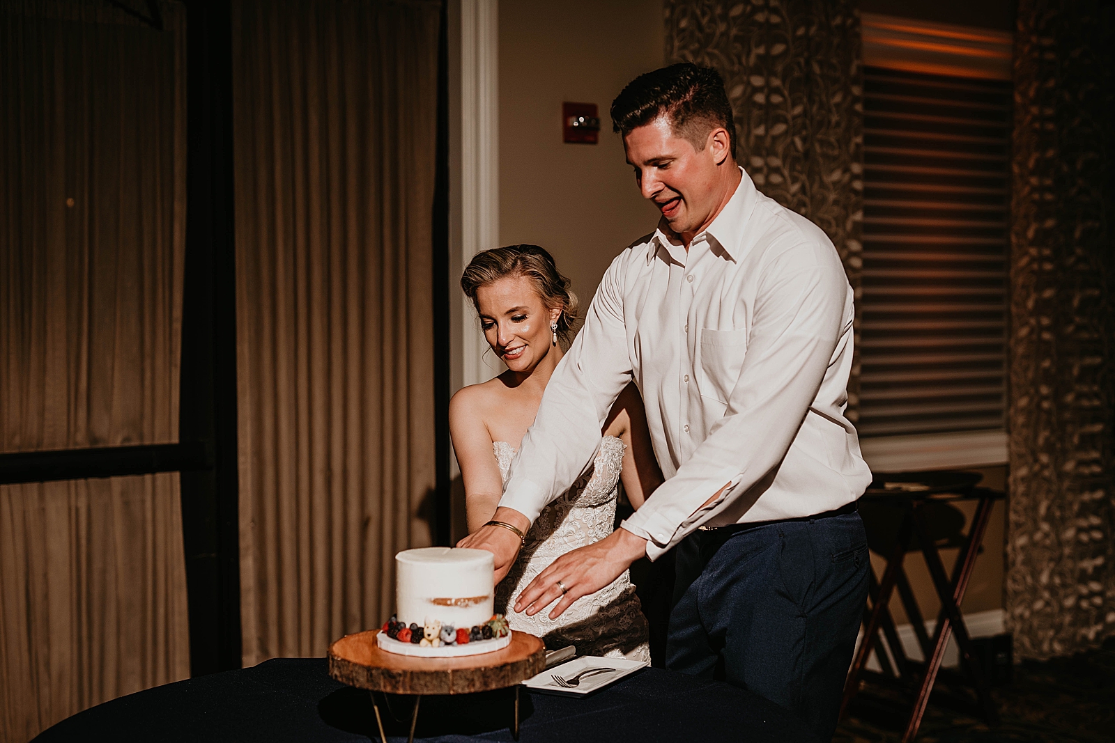 Bride and Groom cutting Wedding cake together
