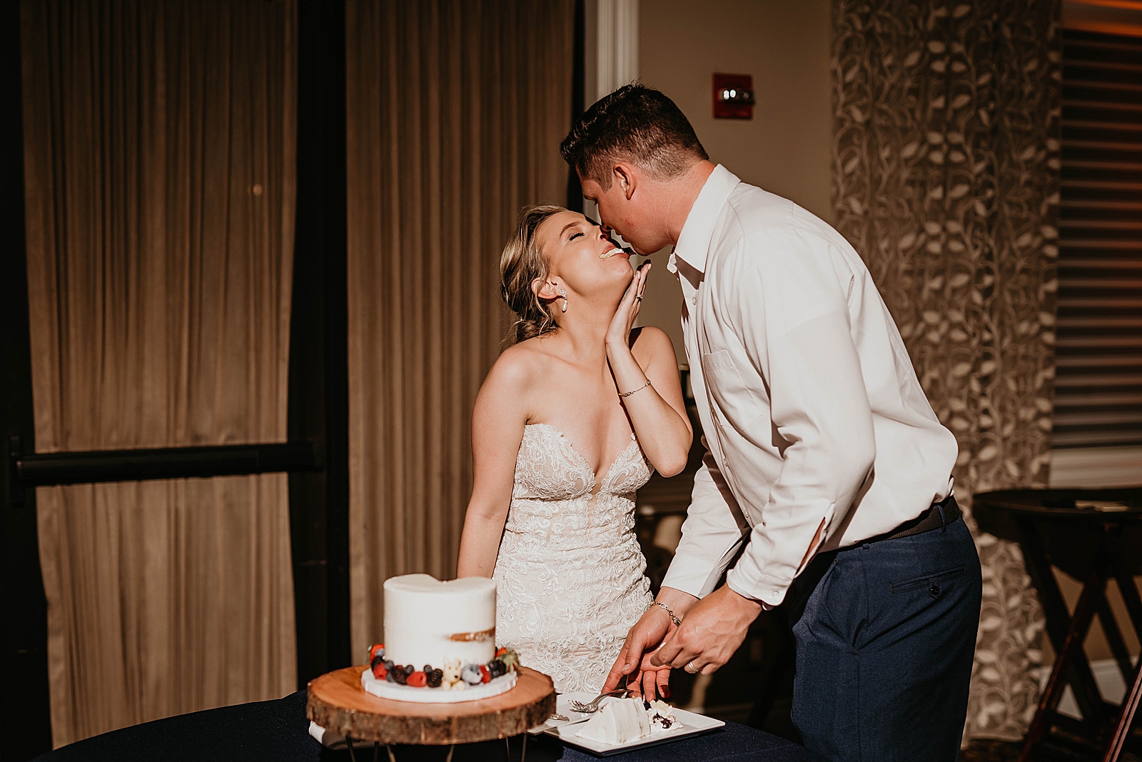 Bride and Groom kissing after cake cutting